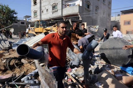 People salvage items from the rubble after an Israeli strike on the Rafah refugee camp in the southern Gaza Strip.