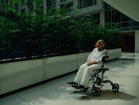 Woman sitting in a wheelchair outside a building