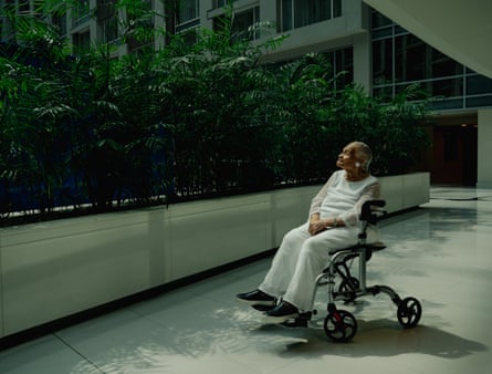 Woman sitting in wheelchair outside building