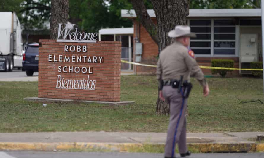An officer walks outside Robb elementary in Uvalde, Texas.