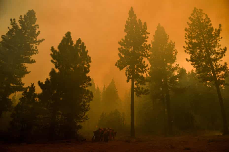Firefighters work to contain the Dixie Fire in California.