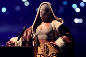 Alicia Keys, in a jewelled face mask, performing in Los Angeles