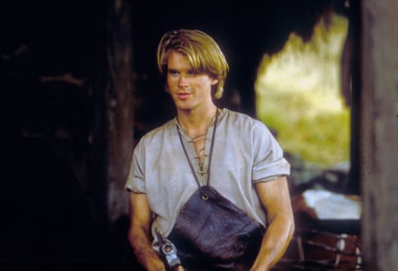 A young man with floppy blond hair is seen smiling.