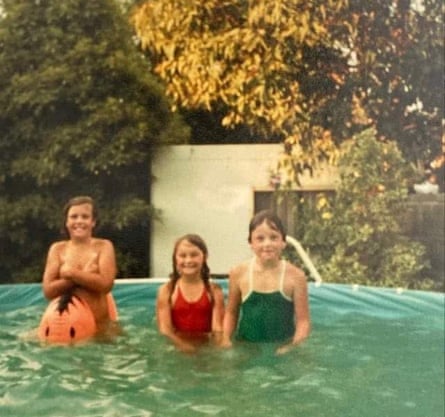 Three young girls in a back yard swimming pool in the 80s