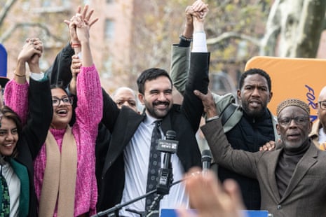 Zohran Mamdani (C) raises his hands during a campaign event with New York City elected officials on 1 November 2025 in Queens.