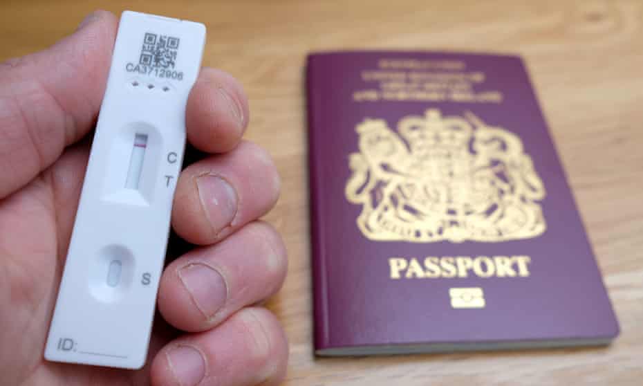 A lateral flow test being held next to a UK passport
