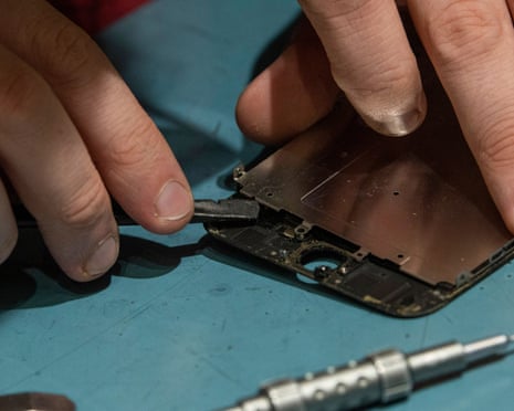 closeup of a pair of hands repairing a smartphone