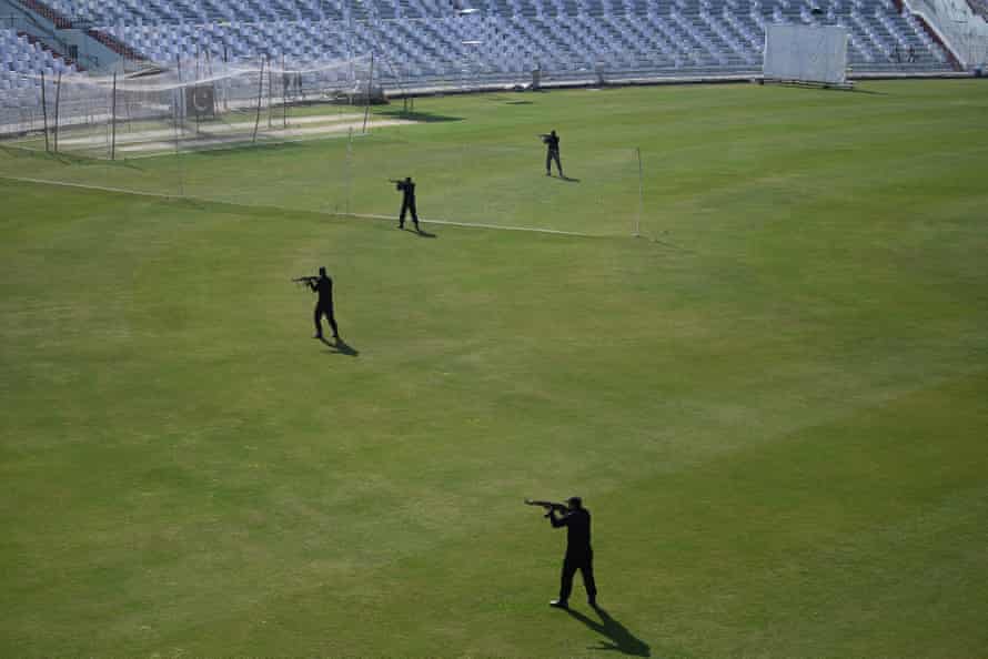 Security personnel conduct a drill before the arrival of the teams for practice at the Rawalpindi Cricket Stadium.