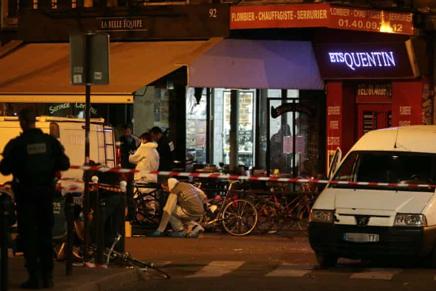 Forensic police search for evidences outside the La Belle Equipe restaurant.