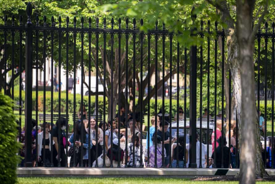 people stand near the fence