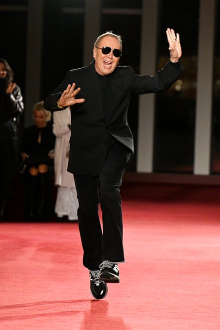 Michael Kors skips on the catwalk.
