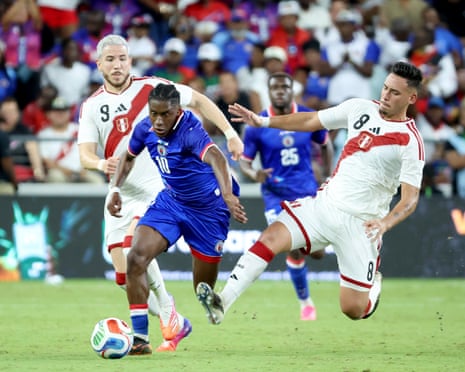 Jean-Ricner Bellegarde of Haiti fights for the ball against Adrian Ugarriza and Erick Noriega of Peru at Nu Stadium on June 5, 2026 in Miami