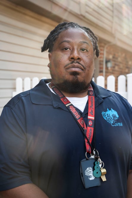 A man with several lanyards around his neck.