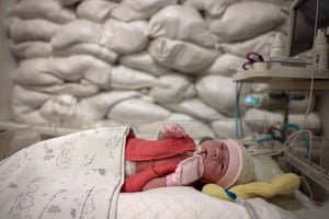Kyiv, Ukraine: a child rests in a cot in front of a window protected by sandbags in the intensive care unit for newborns at Okhmatdyt hospital