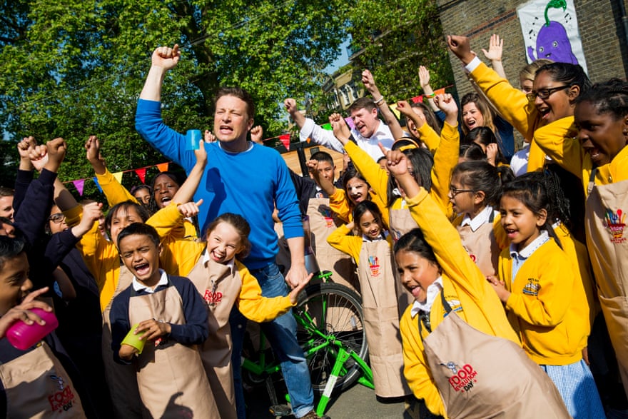 On the campaign trail … Oliver with children from St Paul’s Whitechapel primary school in east London for Food Revolution Day in 2014.