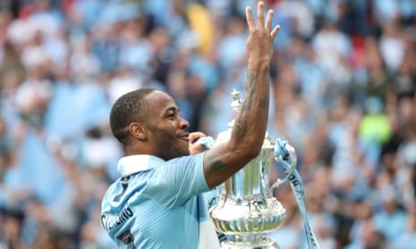 raheem sterling holds the FA Cup trophy after the Manchester City's victory over Watford