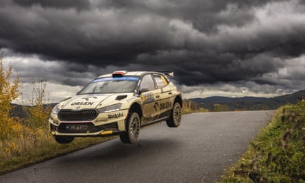 a skoda car leaves the ground during a rally race