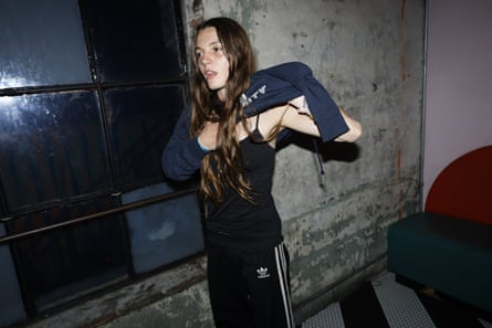 Sophia Stel pulls a sweater over her head