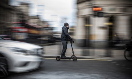 A man riding on an electric scooter in London in 2019
