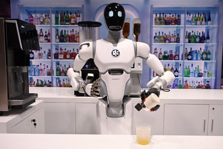 A robot makes a drink at a counter