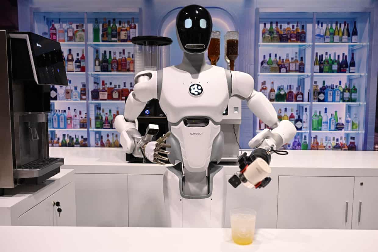 A robot makes a drink at a counter