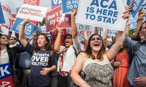 Demonstrators hold signs supporting the Affordable Care Act, commonly known as Obamacare.
