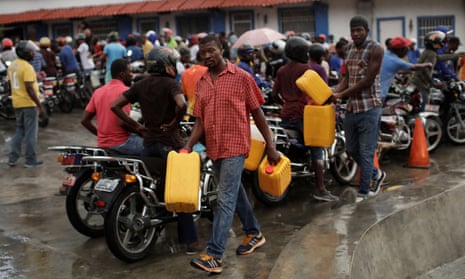 Men carry fuel containers in the capital, Port-au-Prince.