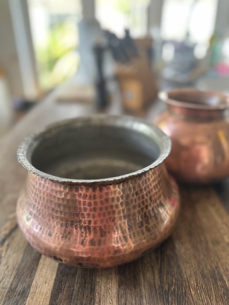 Copper pots on a wooden table