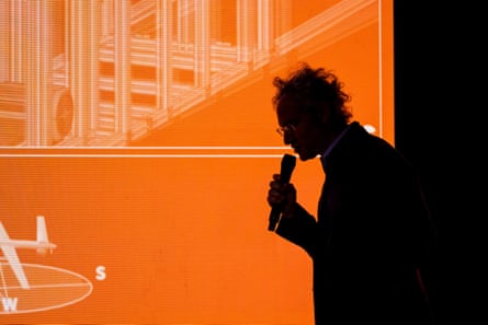 a man is silhouetted while speaking into a microphone