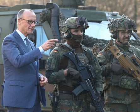 Friedrich Merz with members of the Bundeswehr as he presents the chancellor’s ribbon of honour to the Guard Battalion last month.