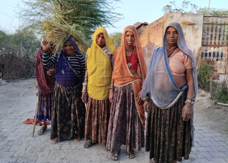 Women who built the wall pose for a picture in Surajpura village