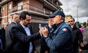 Matteo Salvini, left, is greeted by residents in Rome