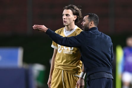Ashley Cole gives Riccardo Ciervo, the Cesena midfielder, some advice on the touchline
