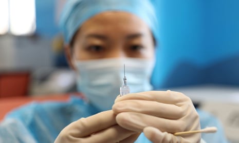 A medical worker prepares a dose of Covid vaccine at a community health centre in Qingdao, Shandong province.