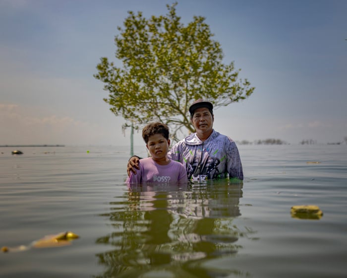 Trees, homes, roads: how the sea is swallowing coastal villages in the Philippines – in pictures