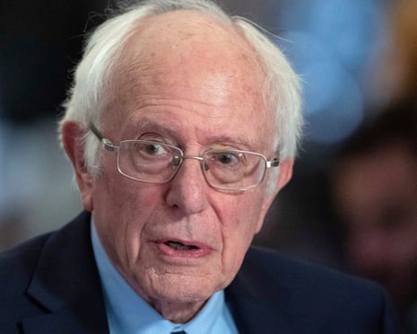 close-up of man wearing glasses and blue suit