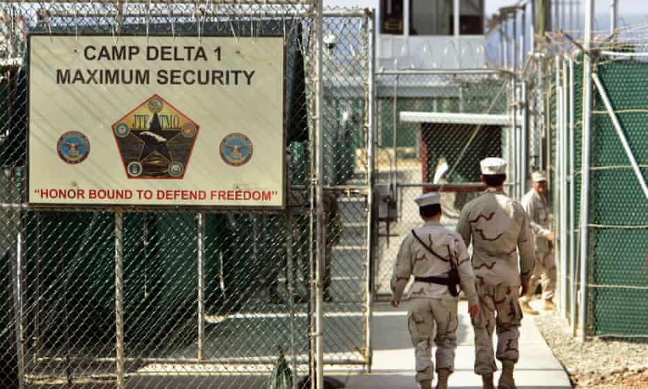 US military guards walk within Camp Delta military-run prison at the Guantánamo Bay US naval base.