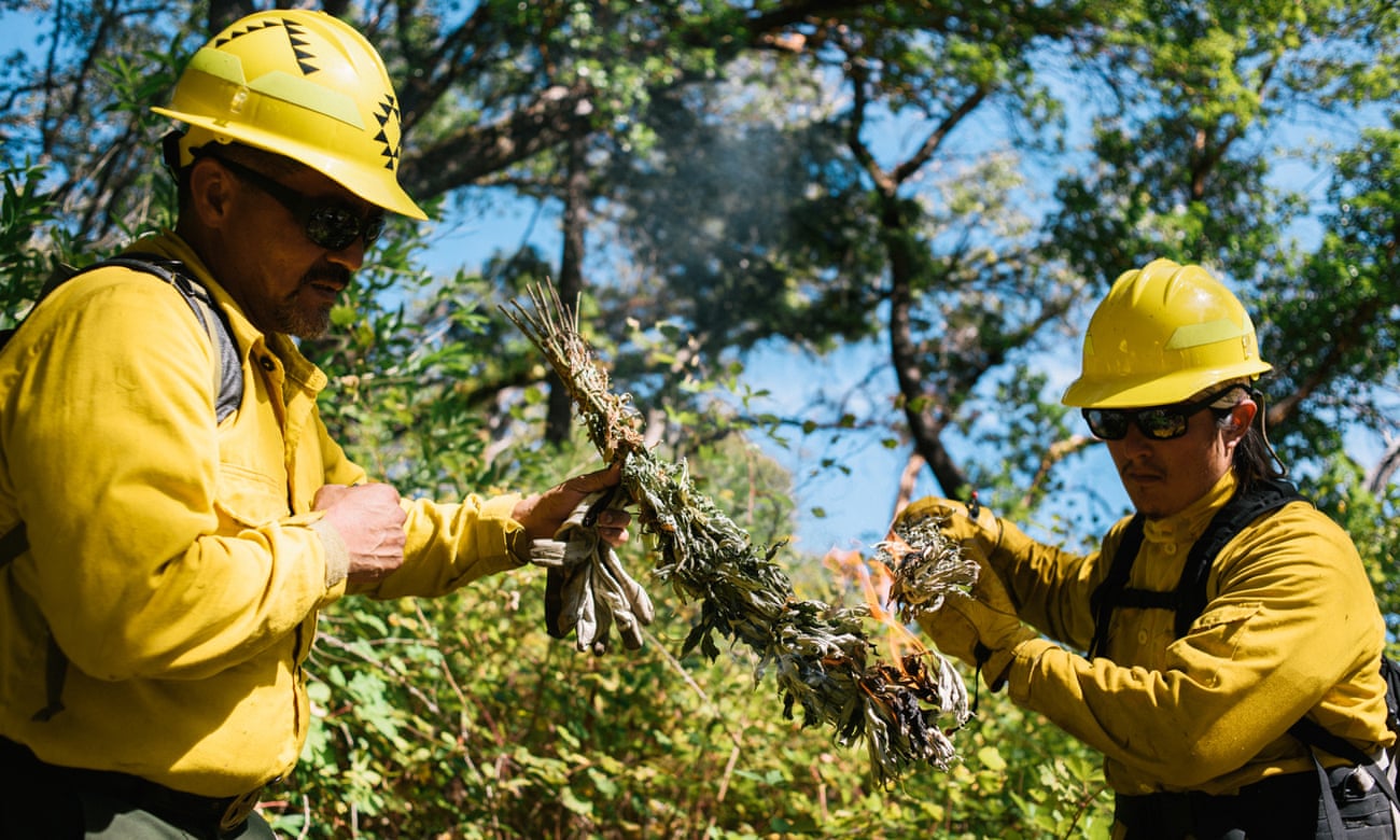 Harold Myers (left) of the Yurok nation and Christopher Villarruel of the Pit River nation start a prescribed burn in the Six Rivers national forest in California.