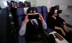 Guests wearing VR goggles take a virtual trip with First Airlines in Tokyo.