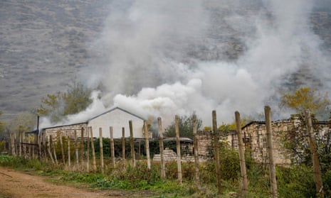 A house burns in the village of Nor-Karmiravan outside Aghdam before its return to Azerbaijan on Friday as part of a Russia deal to end the Nagorno-Karabakh conflict.