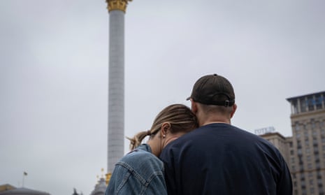 Ukrainians react during the All-National minute of silence in commemoration of Ukrainian soldiers killed in the country's war against Russia on Independence square in Kyiv, Ukraine, Sunday, Oct. 1, 2023. Ukraine commemorates veterans and fallen soldiers on Sunday.