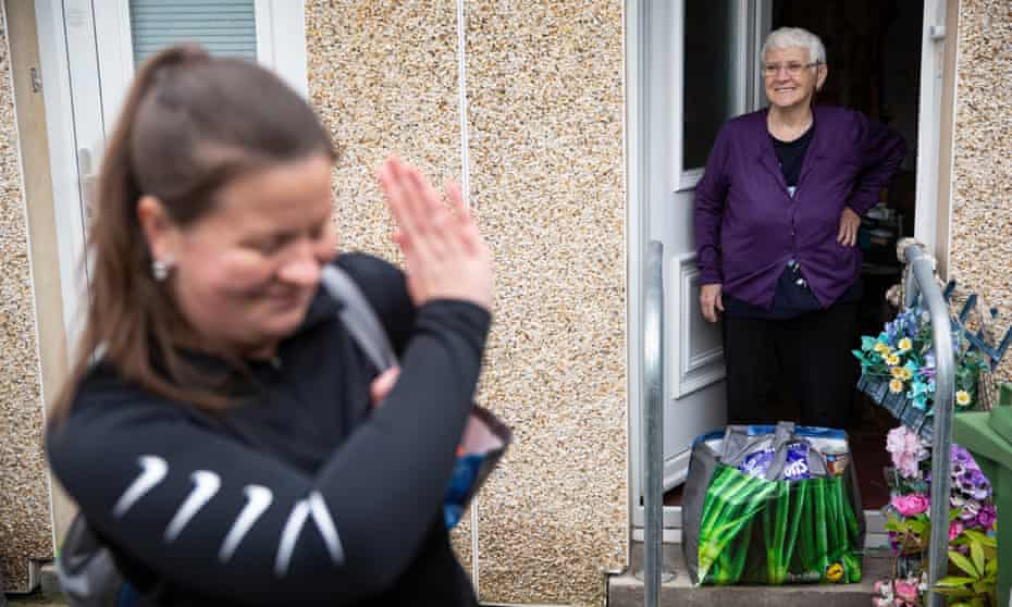 A community worker delivers food parcels to self-isolating elderly people in Glasgow