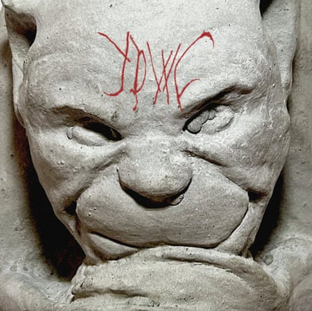 Image of gargoyle with red scribbles on forehead