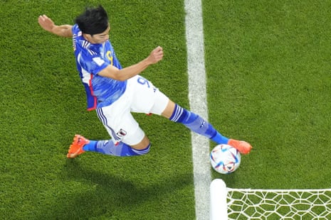 Japan's Kaoru Mitoma appears to have the ball over the line before crossing it for a goal