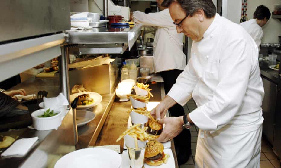 French Chef Daniel Boulud arranges a serving of “The Original db Burger” at his DB Bistro Moderne in New York