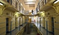 Interior of Victorian prison showing cells, netting and one prisoner