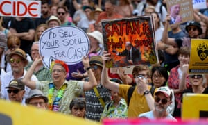 Protesters hold placards during a ‘Sack ScoMo!’ climate change rally in Sydney on 10 January 2020.