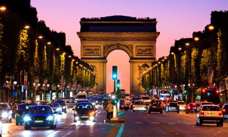 The Arc de Triomphe and Champs Élysées in Paris at night.