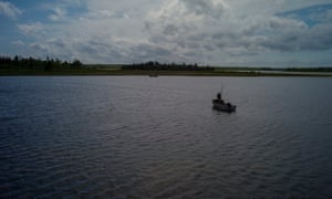 An oyster fisherman using the traditional tonging method on the Grand river, off Malpeque Bay 