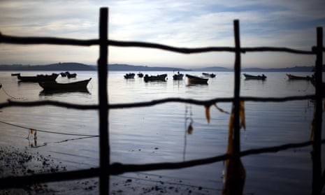 Fishing boat moored in a region of Chile affected by the largest red tide in its history, prompting fishermen deprived of their livelihoods to angrily demand government support.